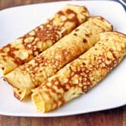 Pannenkoeken are served on a white plate.