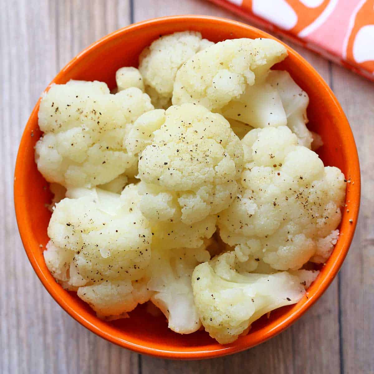 Microwave cauliflower is served in a bowl with a napkin.