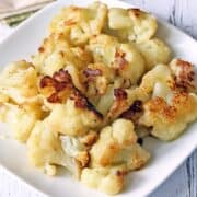 Sauteed cauliflower is served on a white plate.