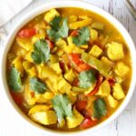 Turkey curry is served in a white bowl.
