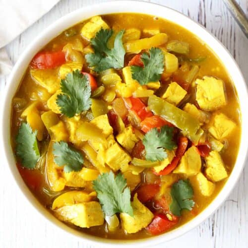 Turkey curry is served in a white bowl.