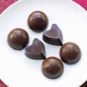 Homemade chocolate is served on a white plate.