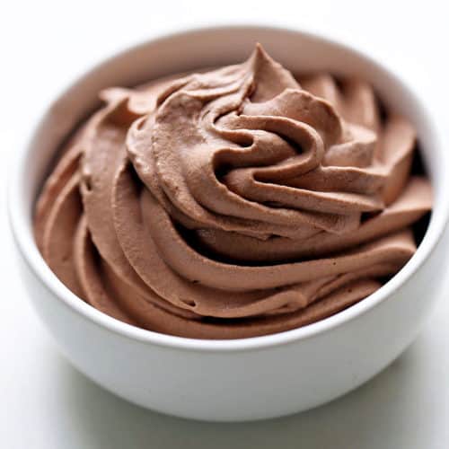 Chocolate whipped cream is served in a white bowl.