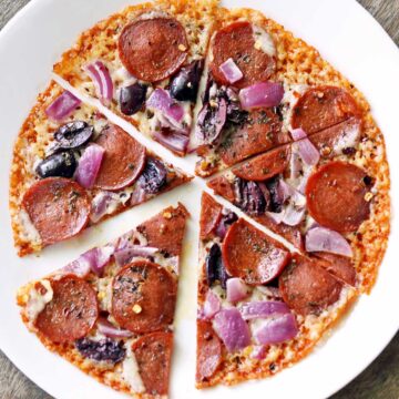 Crustless pizza is served on a white plate.
