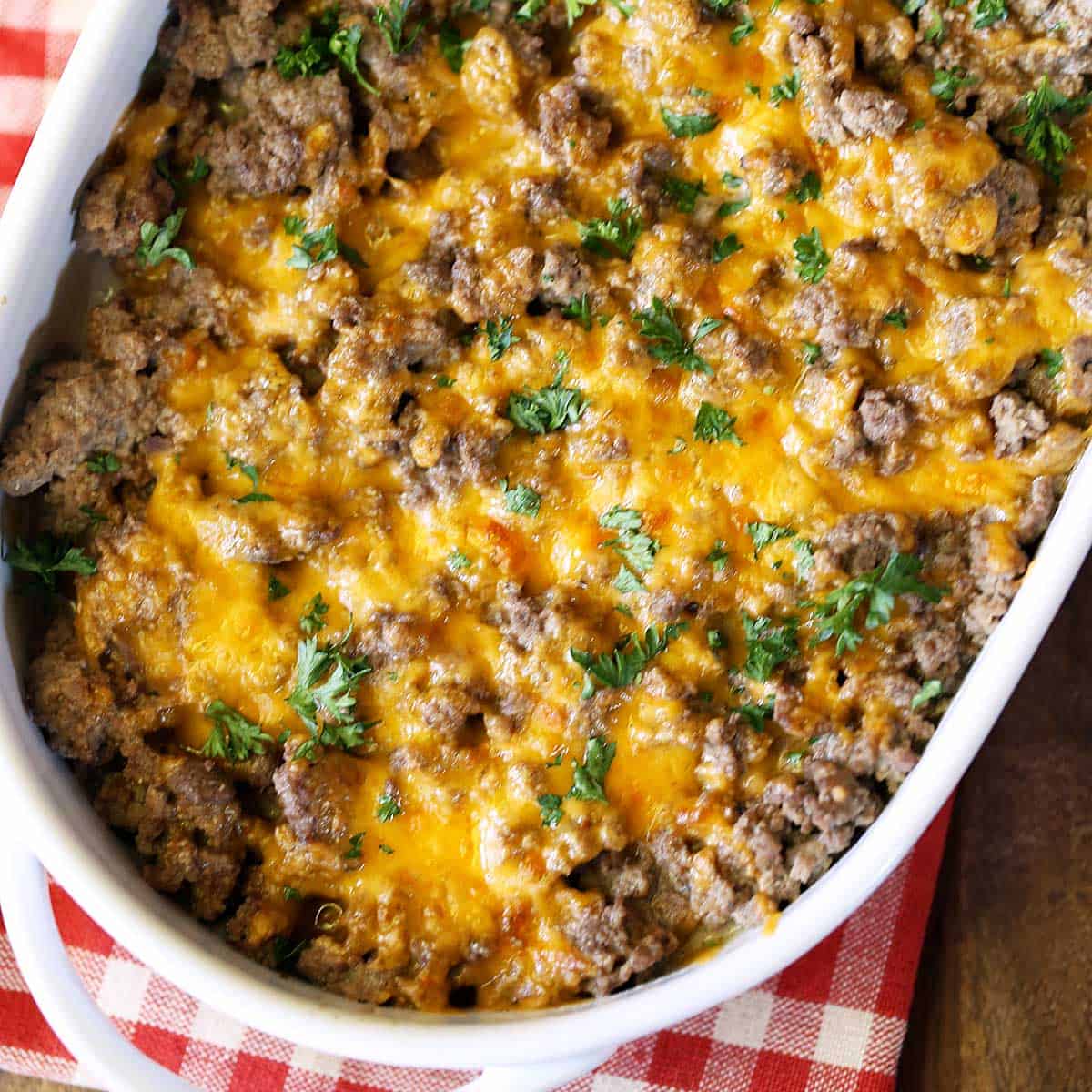 Ground beef casserole is served in a white baking dish.