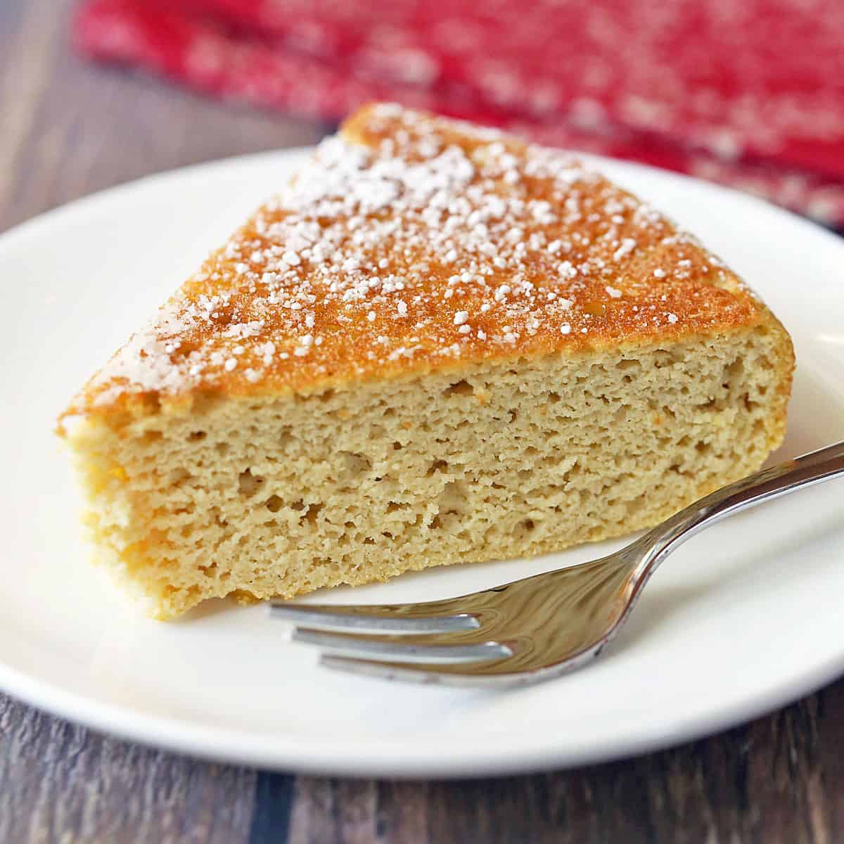 Coconut flour cake is served on a plate with a fork.