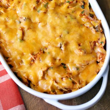 Keto enchilada casserole is served in a white baking dish with a napkin.