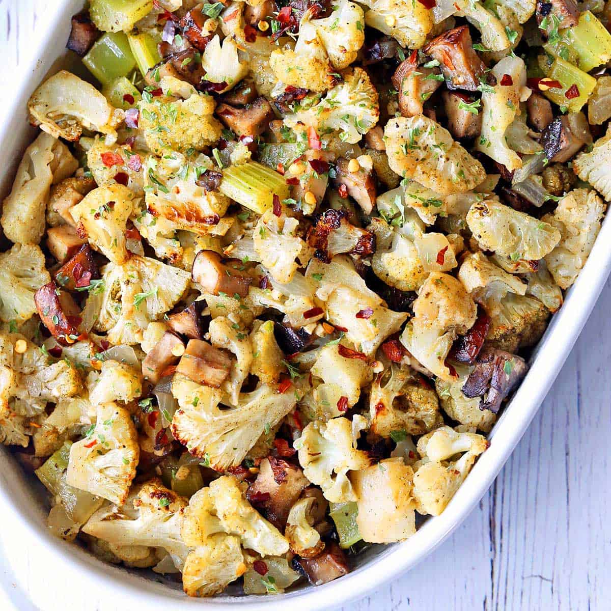 Cauliflower stuffing is served in a white baking dish.