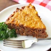 Keto meat pie is served on a white plate with a fork.