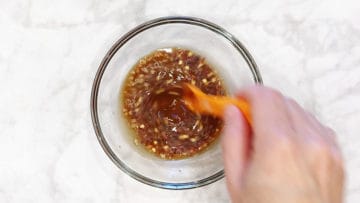 Mixing the sauce in a small bowl.