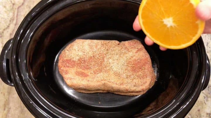Squeezing orange juice on the meat.