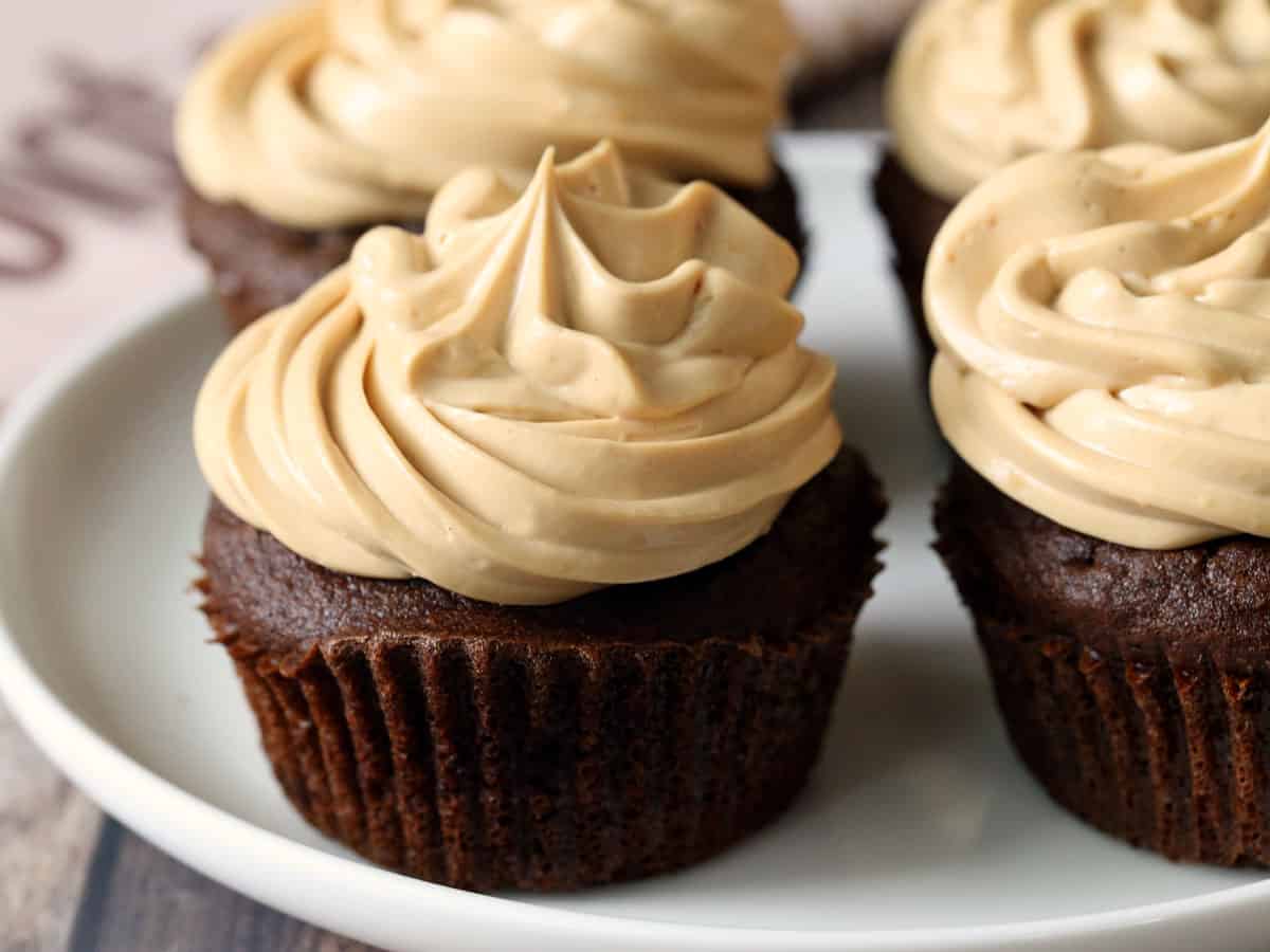 Keto chocolate cupcakes are served on a white plate.