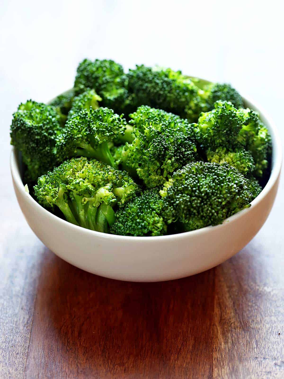 Microwave broccoli is served in a white bowl. 