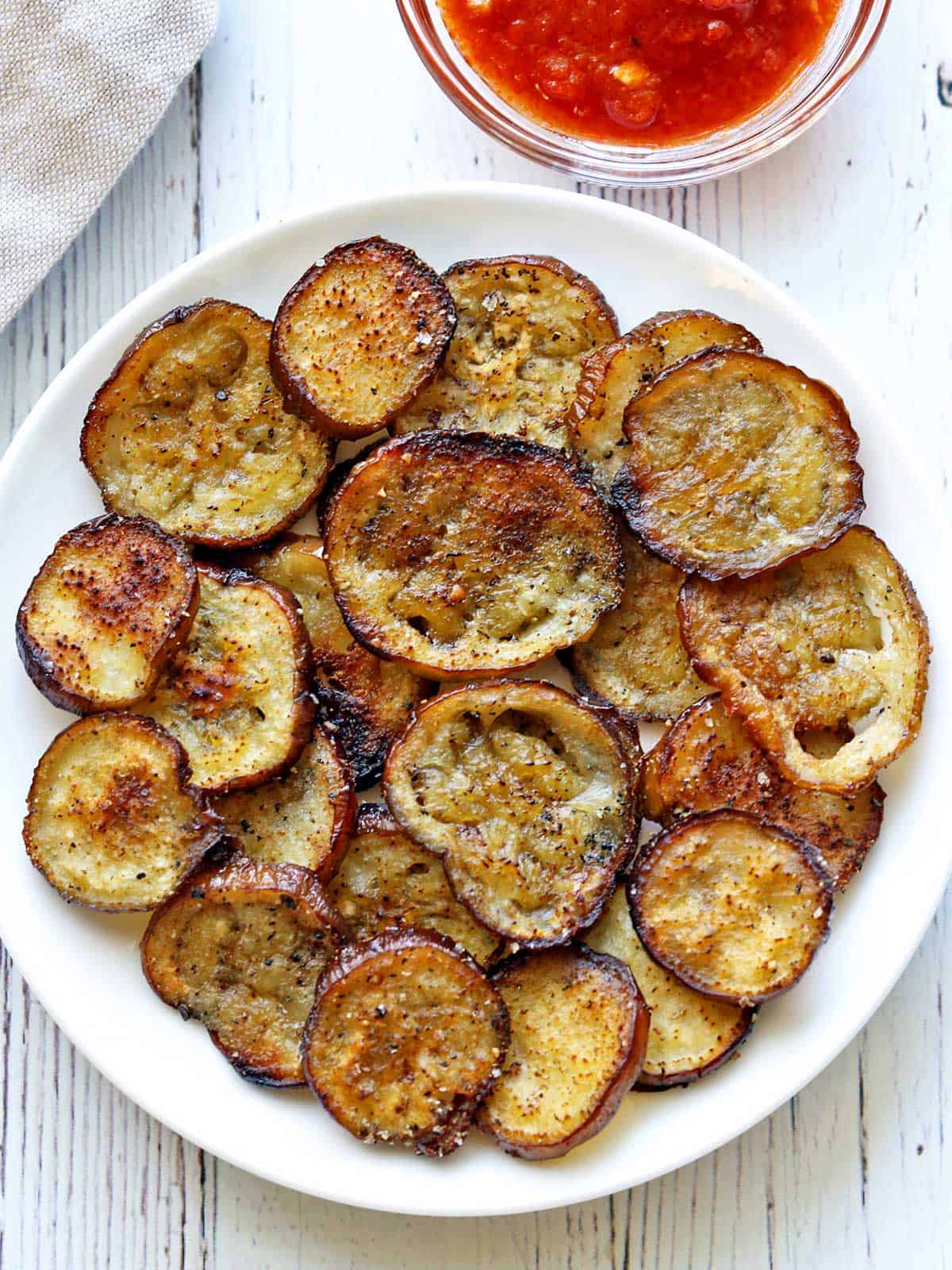 Eggplant chips are served with salsa for dipping. 