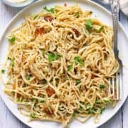 Hearts of palm pasta is served on a white plate with a fork.