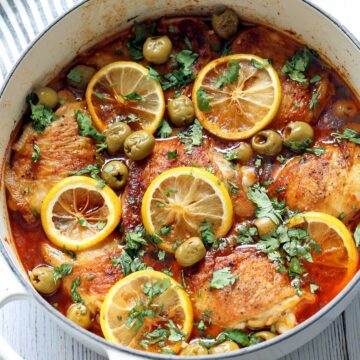 Moroccan chicken is served in a white saucepan.