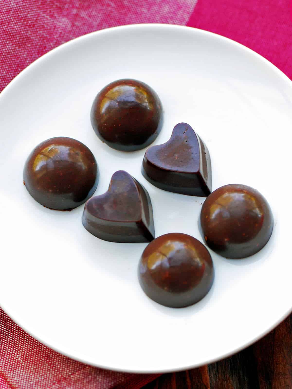 Homemade chocolate is served on a white plate.