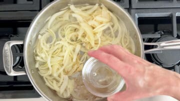 Adding water to the skillet.