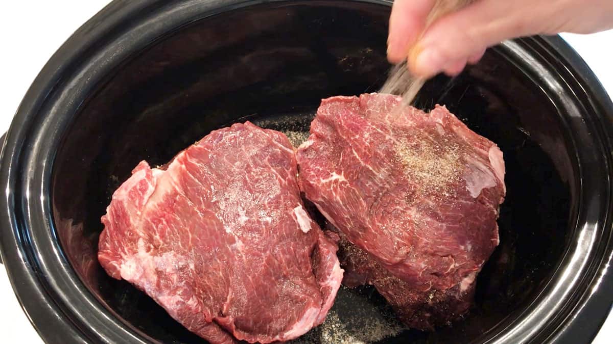 Sprinkling beef cheeks with spices.