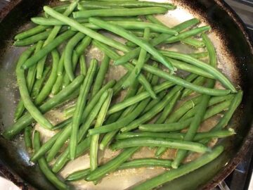The green beans were added to the skillet.