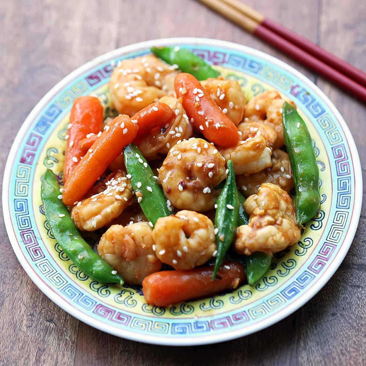 Shrimp stir fry with carrots and snow peas.