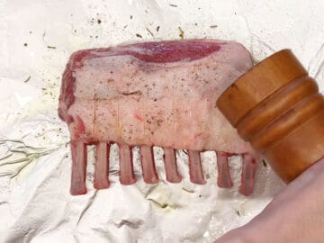 Seasoning the lamb.