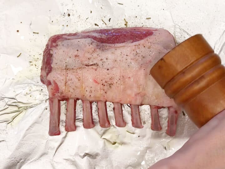 Seasoning the lamb.