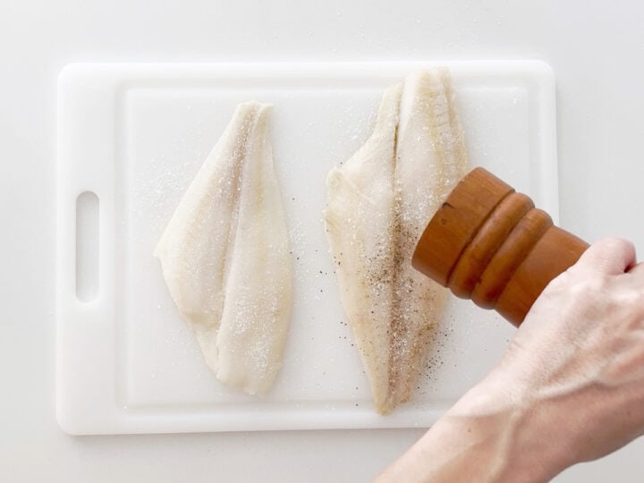Seasoning the fish.
