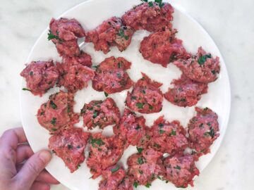 Dividing the meatball mixture into equal portions.