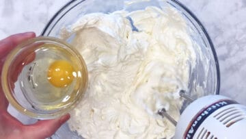 Adding eggs.