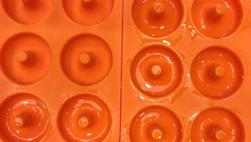Grease the donut pan cavities.