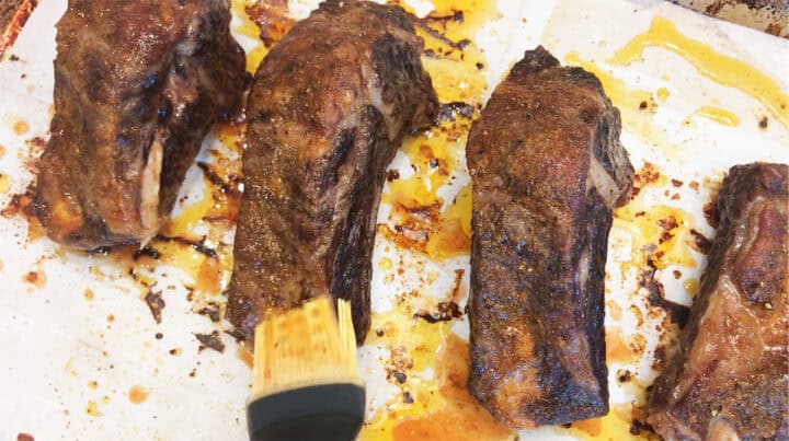 Basting the ribs again.