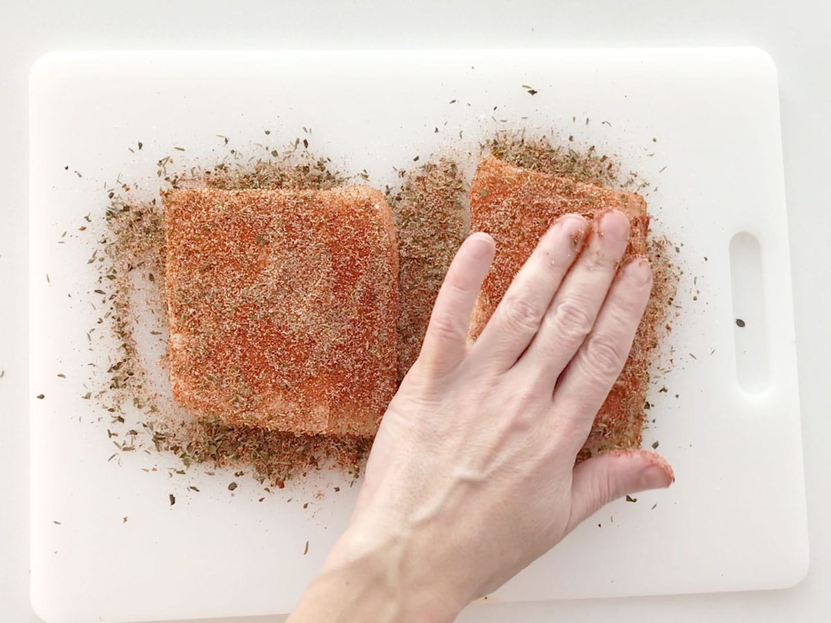 Seasoning the fish.