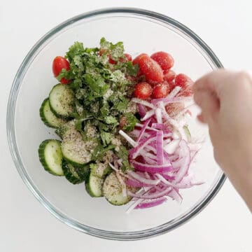 Adding spices to the salad.