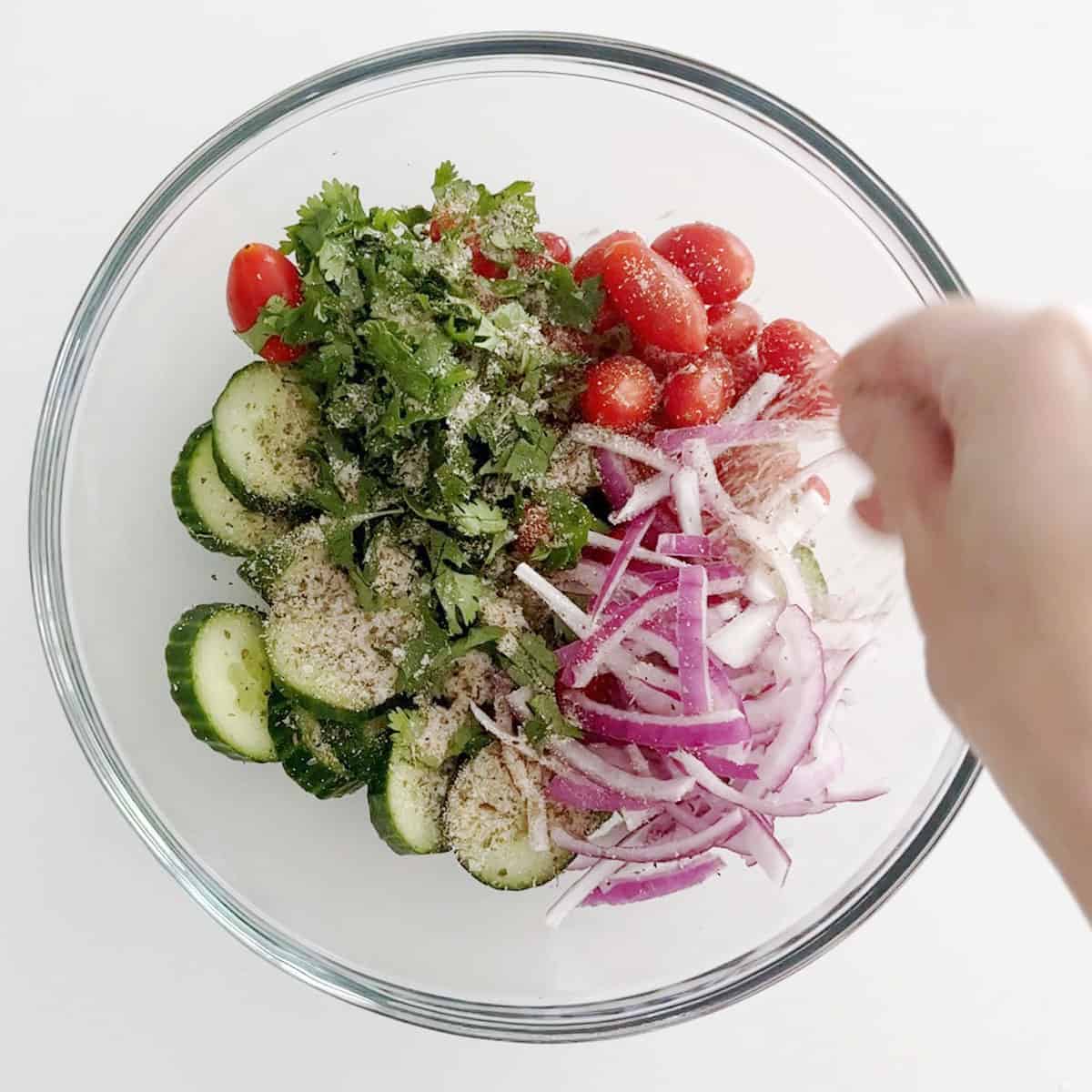 Adding spices to the salad.
