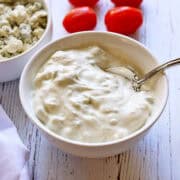 Blue cheese dressing is served in a bowl.