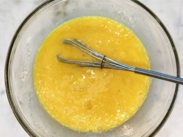 Whisking the liquid ingredients in a bowl.