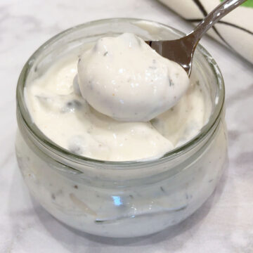 Homemade tartar sauce is served with a spoon.