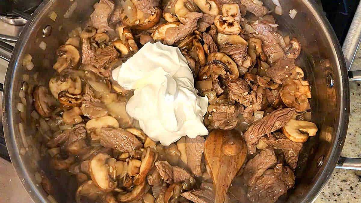 Adding sour cream.