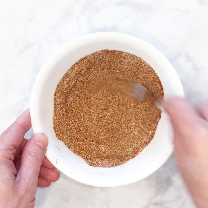Mixing spices in a white bowl.