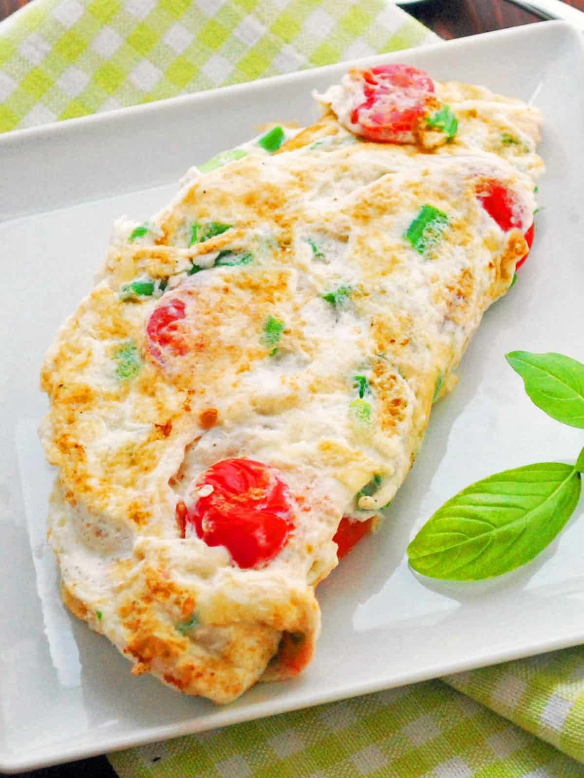 An egg white omelette is served on a white plate.