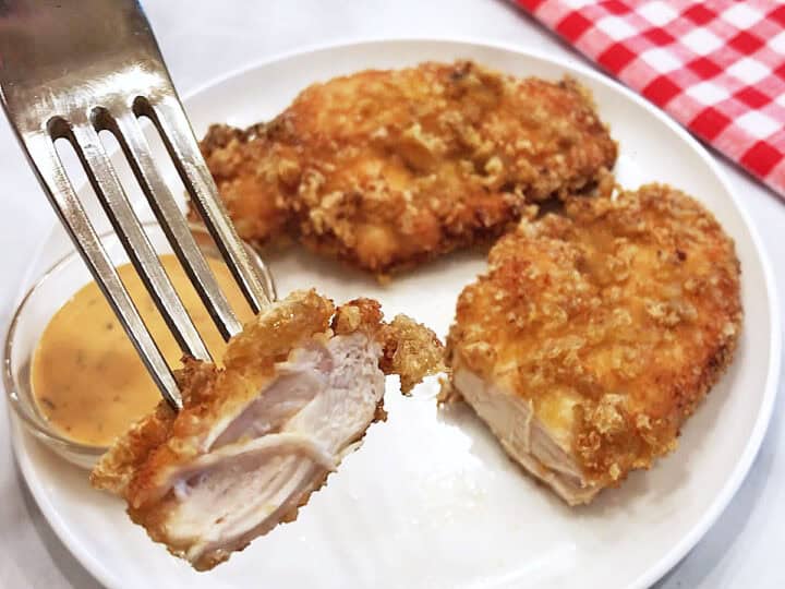 Showing off the perfectly cooked inside of a chicken tender.