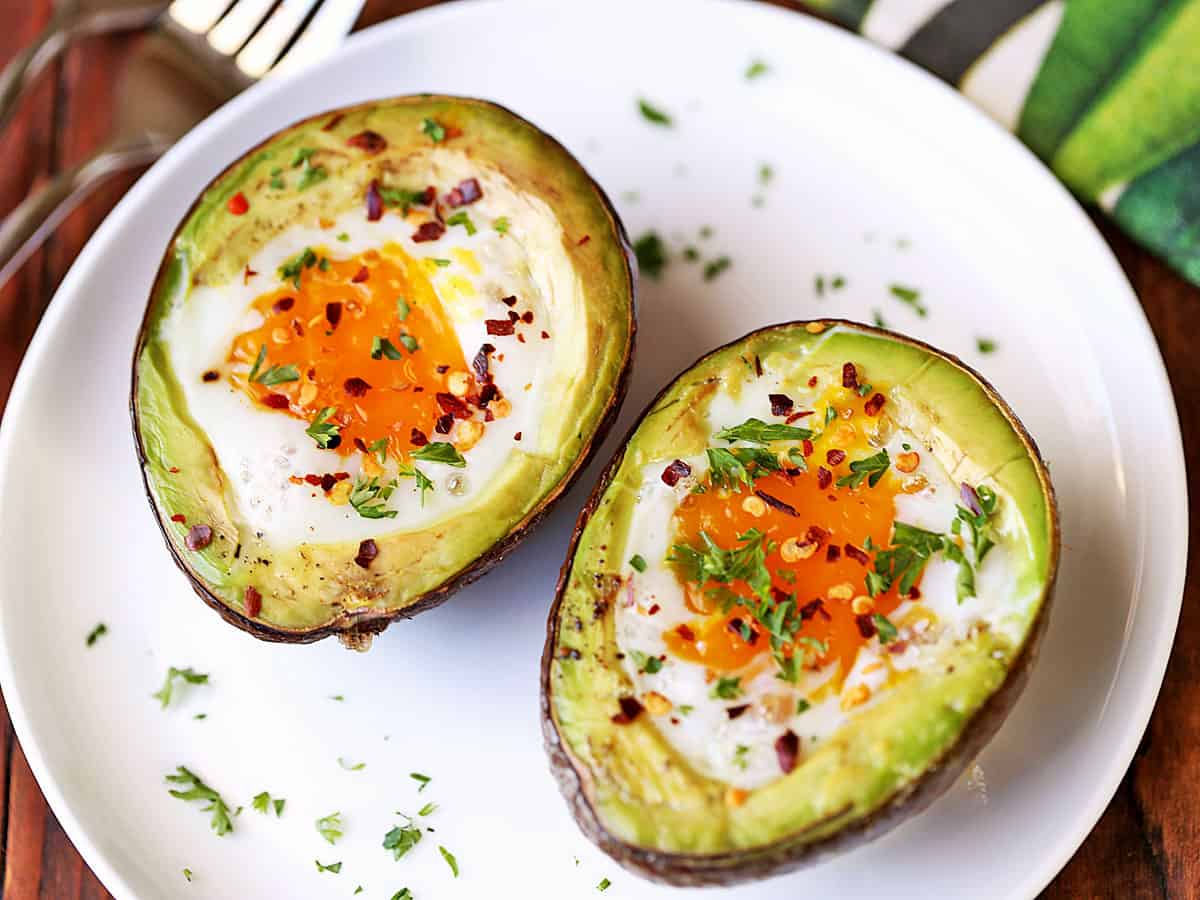 Baked avocado egg with the film removed from the yolks.