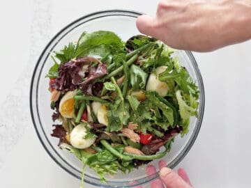 Mixing the salad.