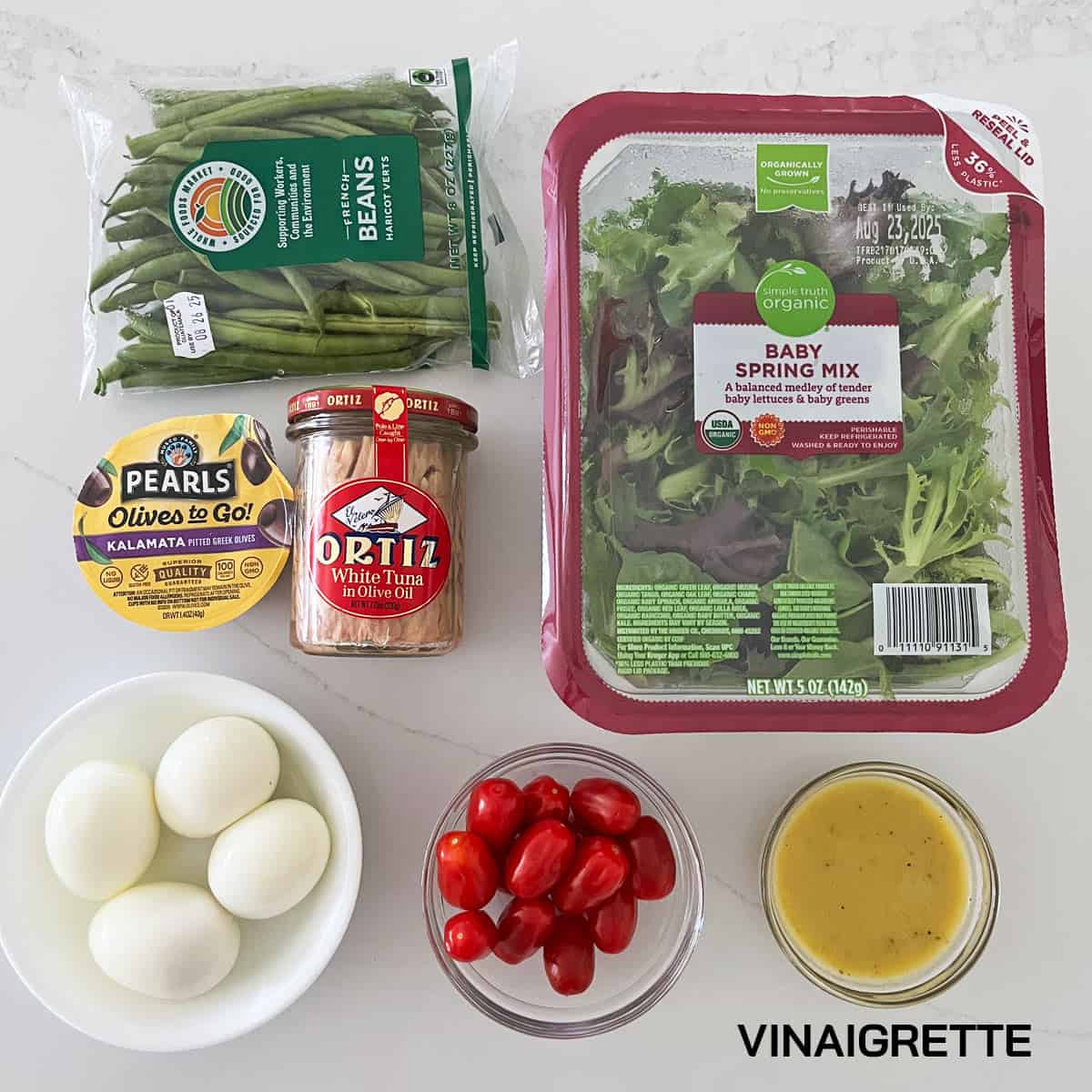 The ingredients needed to make nicoise salad.