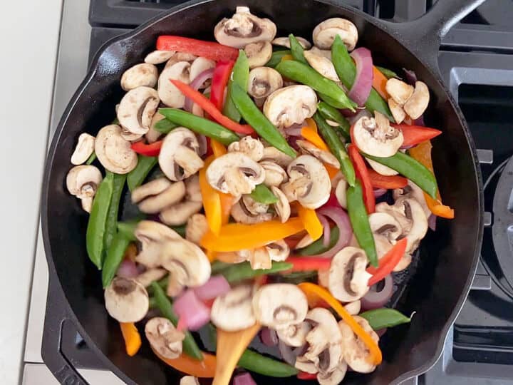 Sauteing the veggies in a skillet.
