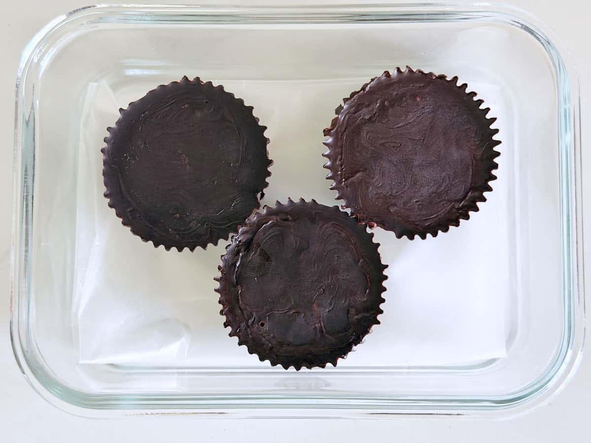 Peanut butter cups stored in a glass container.