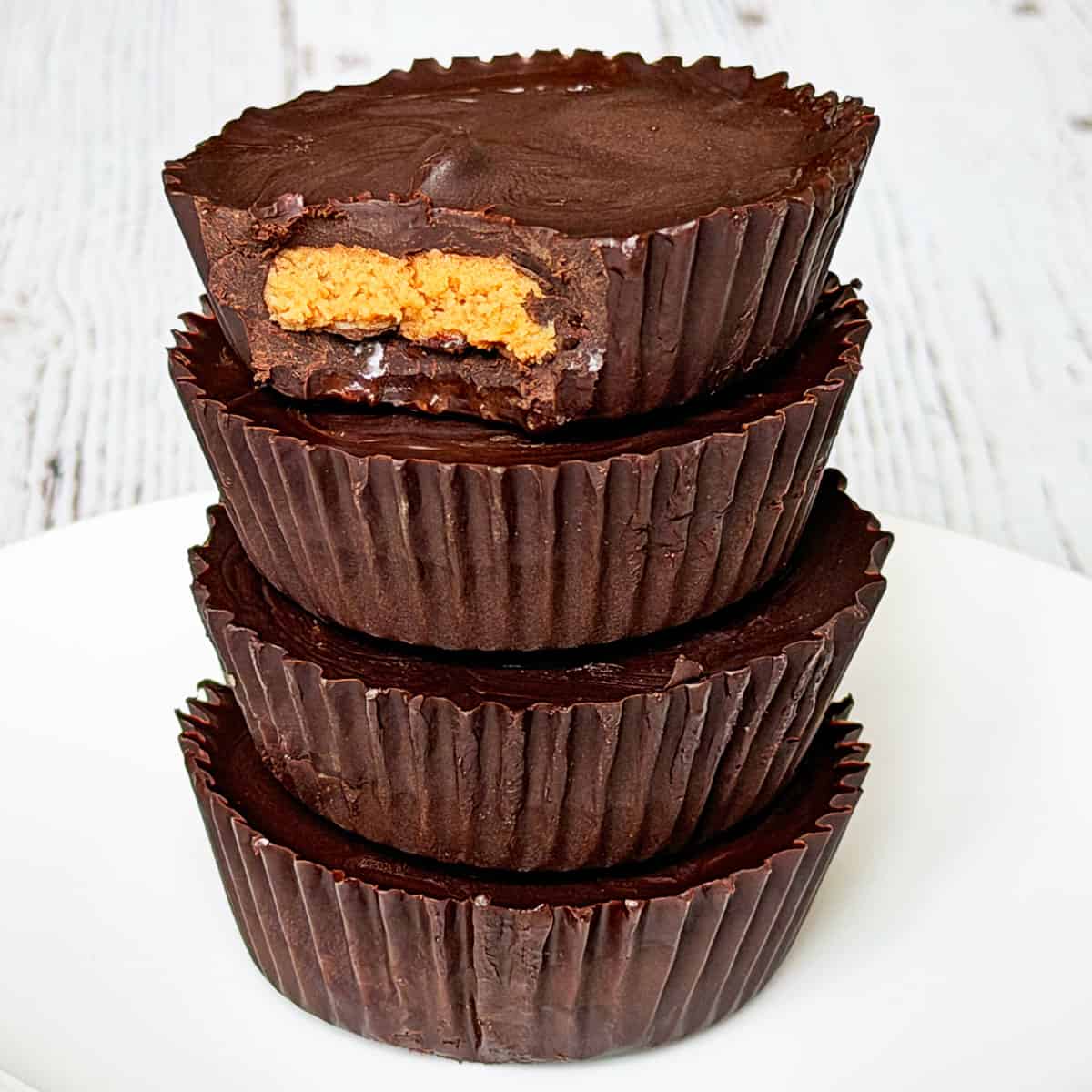 A stack of keto peanut butter cups on a plate.