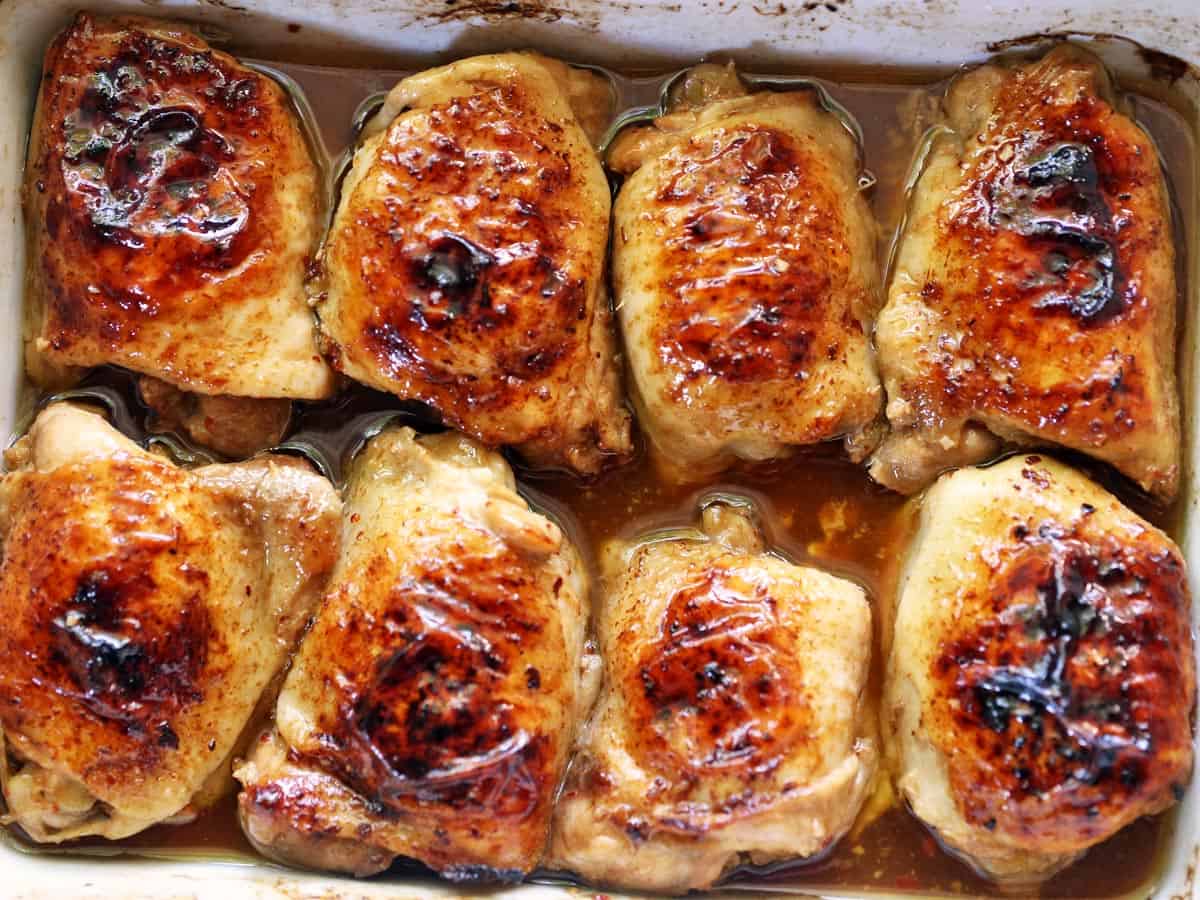 Soy sauce chicken thighs in a pan.