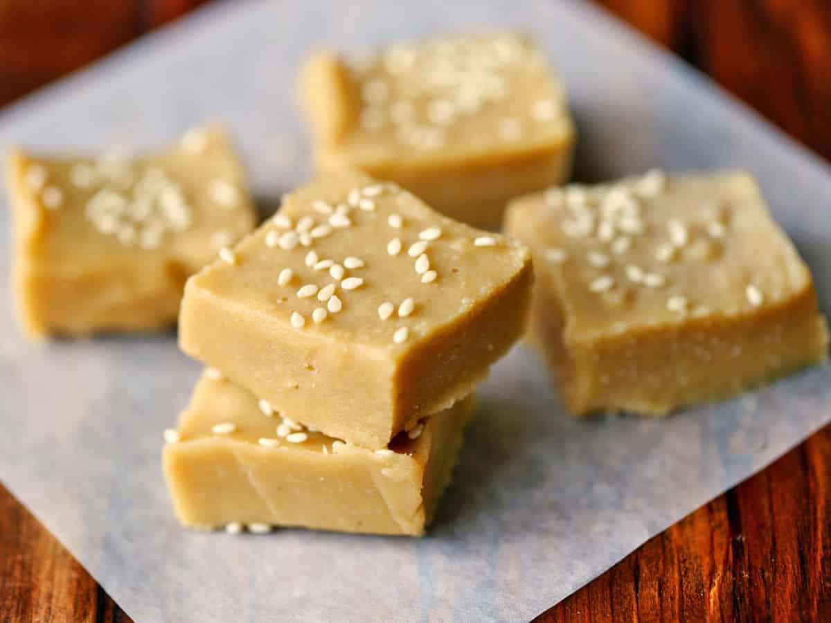 Tahini fudge is topped with sesame seeds.